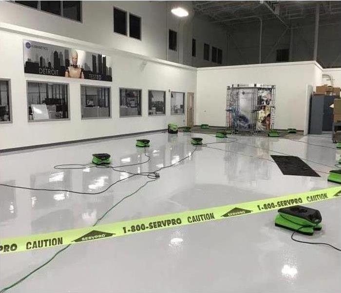 Water damage with caution tape in a commercial warehouse